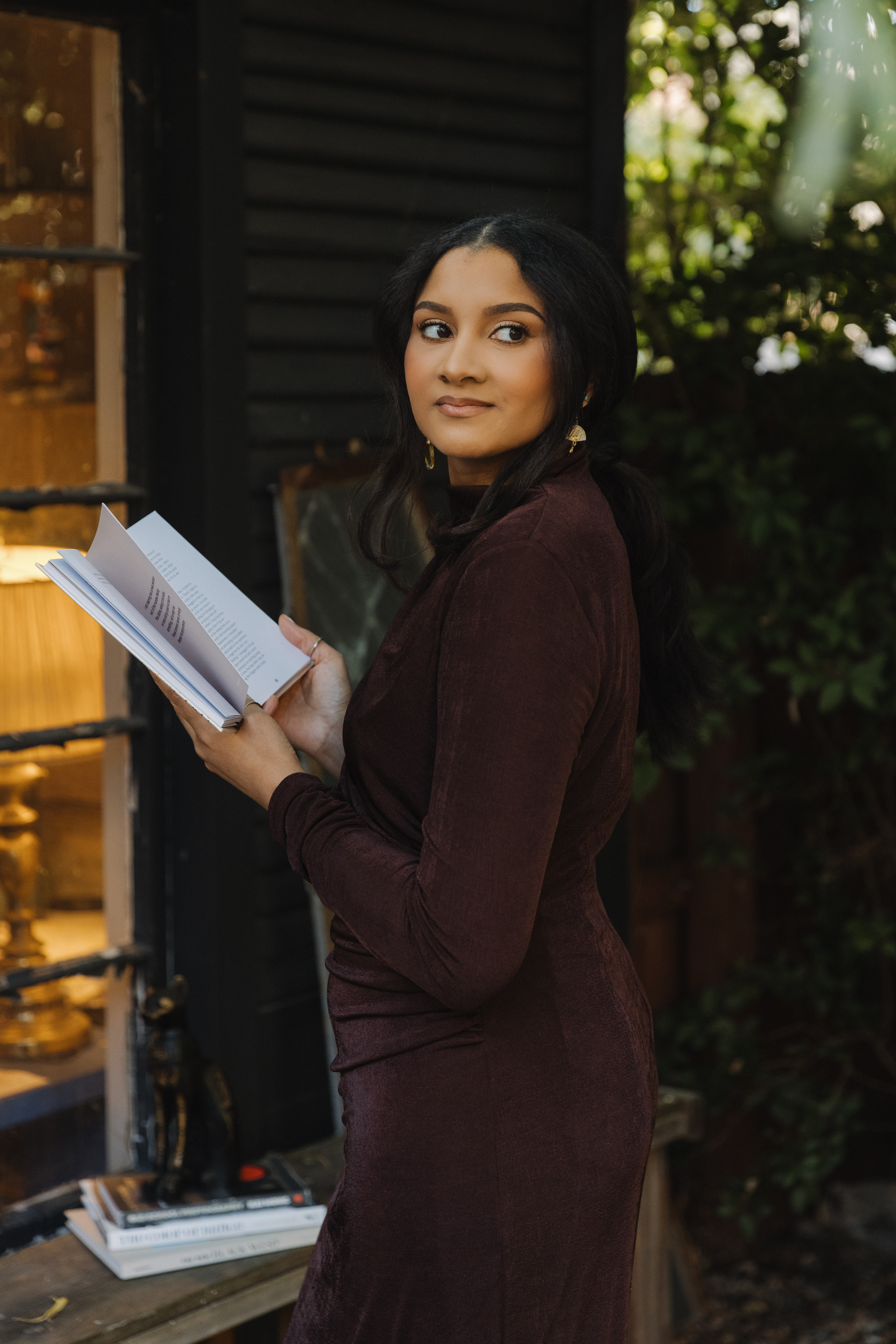 Victoria reading a book outdoors, with the words “a love letter to the ‘chosen ones’” beneath her.